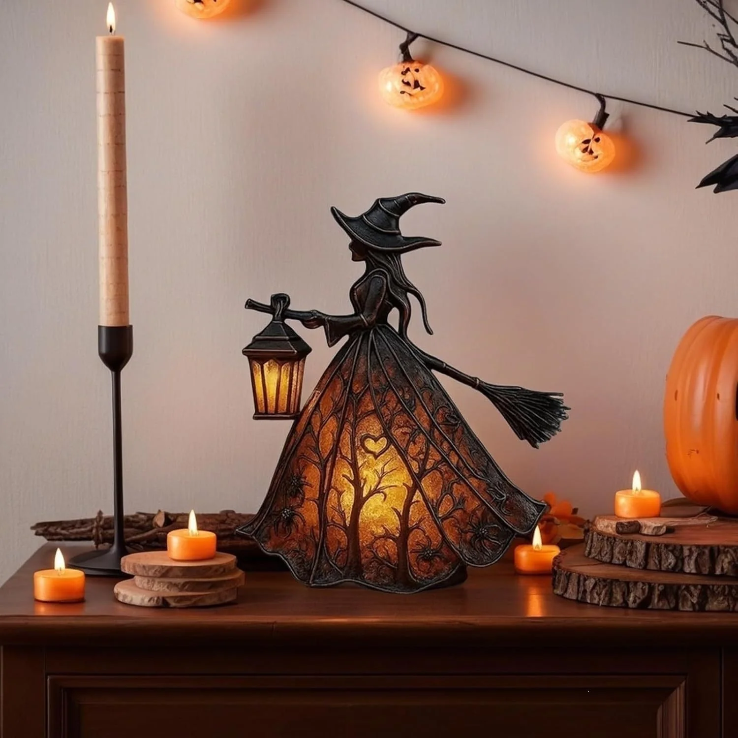 Halloween witch lamp displayed on a tabletop with candles and pumpkin lights