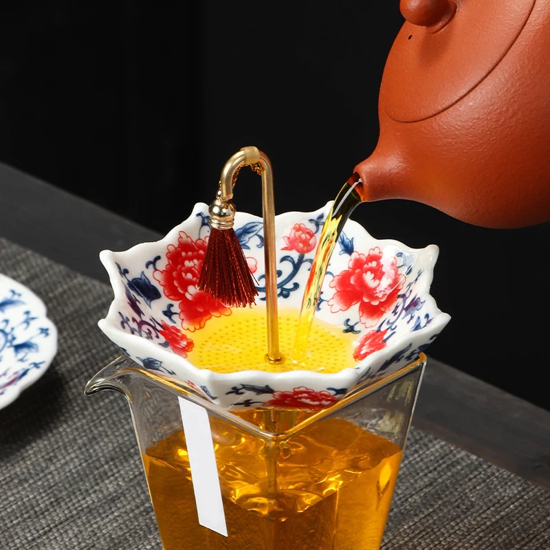 Ceramic tea strainer filtering freshly brewed tea