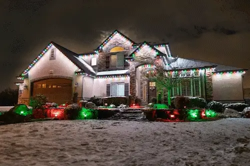 Outdoor lights changing color along a house roofline