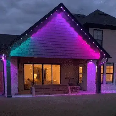 Flowing color effects illuminating a house wall beneath the roofline