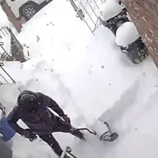 Beleno Cordless Snow Shoveler auger lifting and throwing snow off a walkway