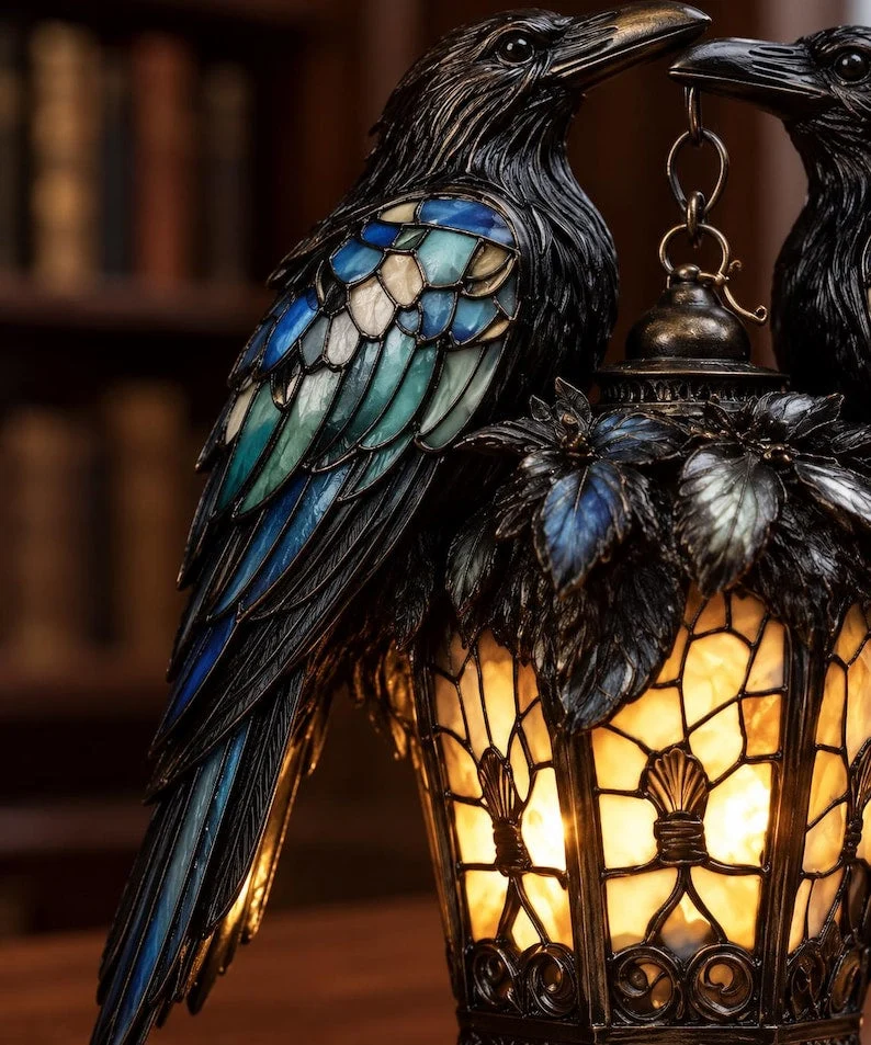 Close-up showing blue turquoise and cream stained glass style raven wings and ornate lantern