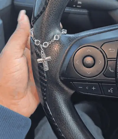Actual product video showing the silver-tone beaded cross charm in natural light