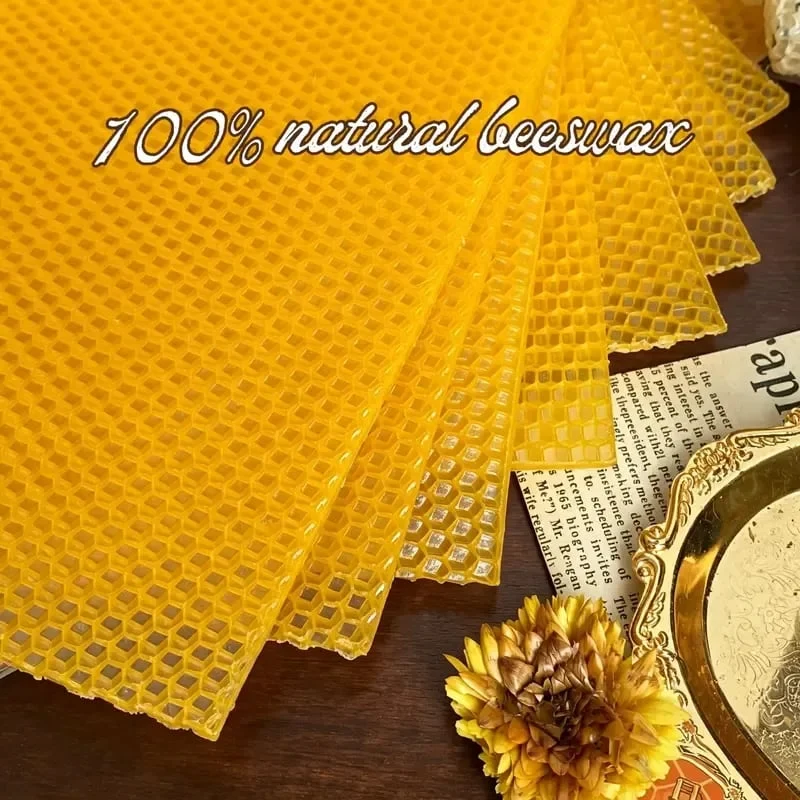 Close-up detail of golden beeswax sheets showing natural honeycomb texture