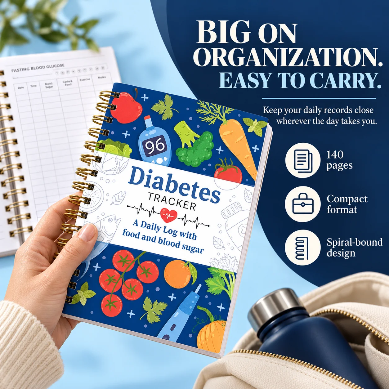 Compact blue spiral-bound Diabetes Tracker held in one hand