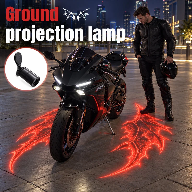 Black sport motorcycle and rider at night surrounded by dramatic red devil-wing ground projections