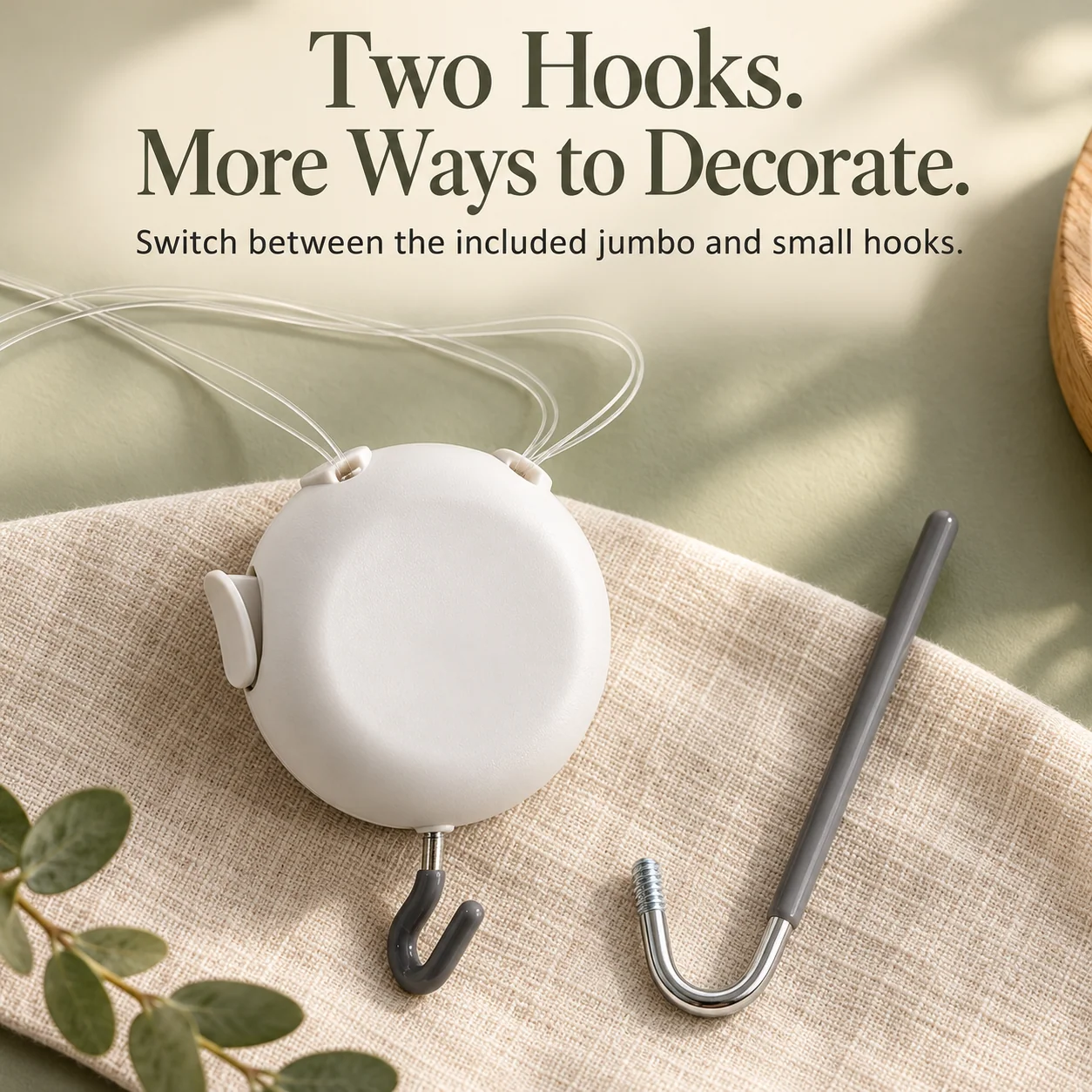 White circular wreath hanger with transparent lines, a small gray hook and a separate longer gray hook attachment