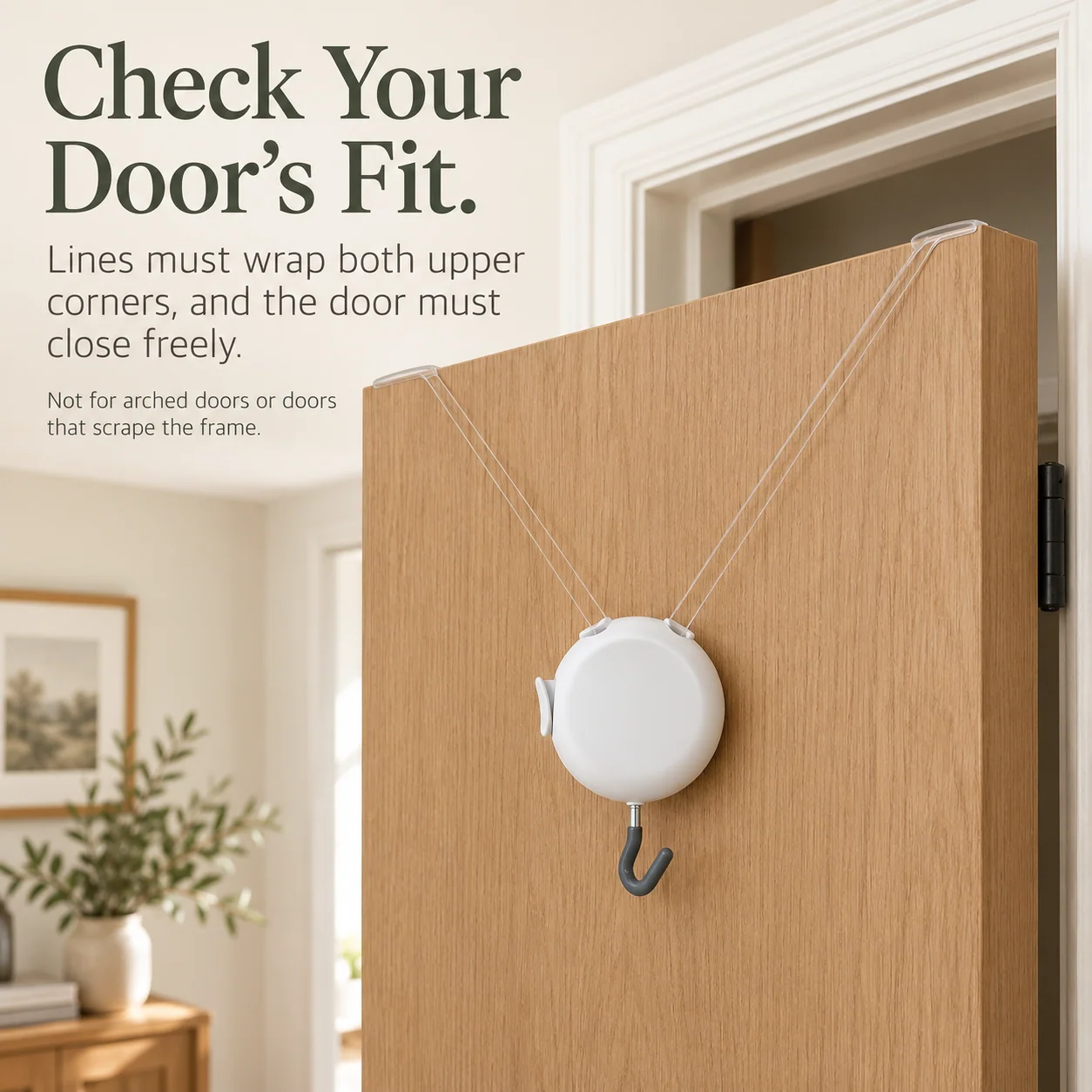White adjustable wreath hanger suspended from both upper corners of an open wooden door